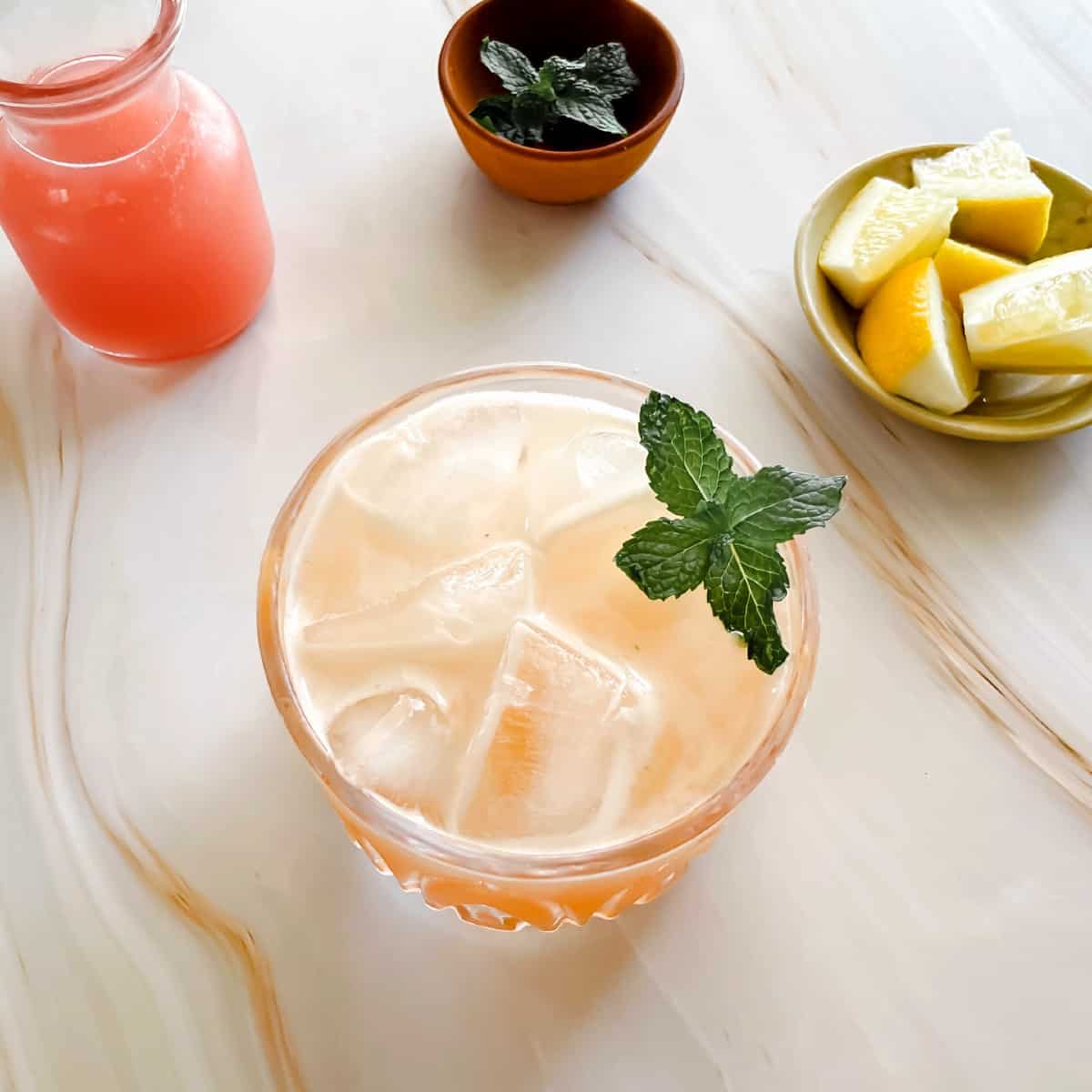 whiskey guava smash with a sprig of mint