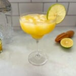 mango margarita with lime garnish.