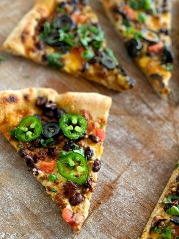 a slice of taco pizza with jalapenos.