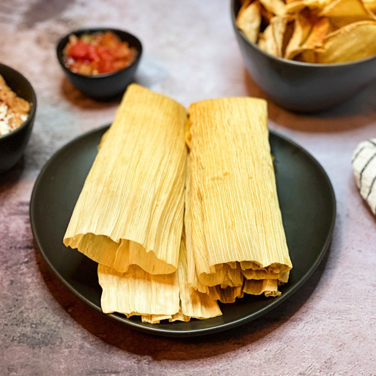 red chili tamales and side dishes.