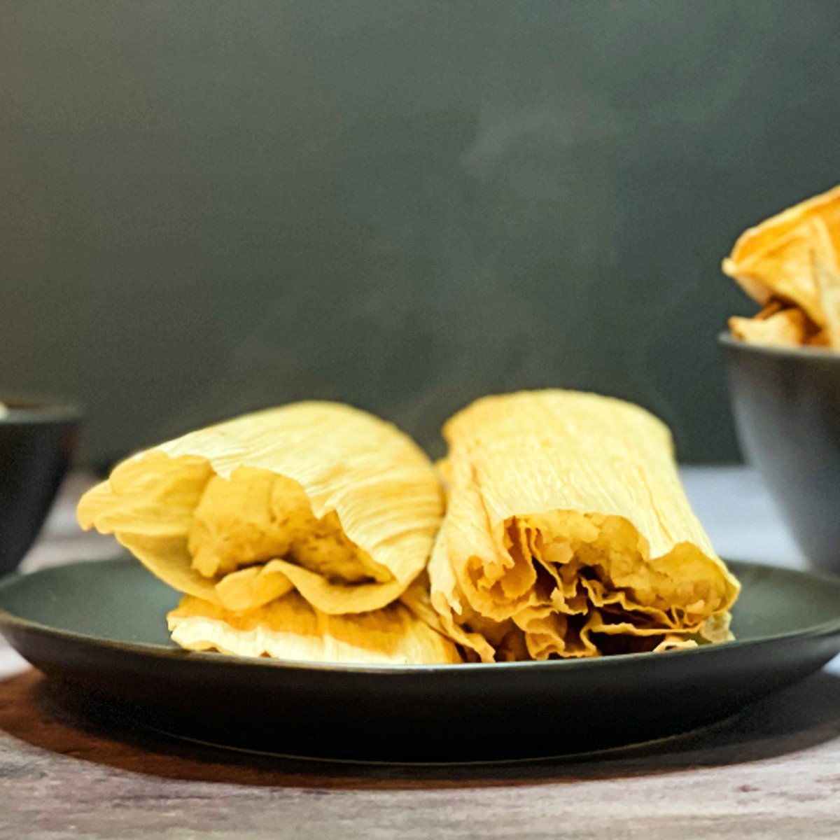 red pork tamales on a plate.