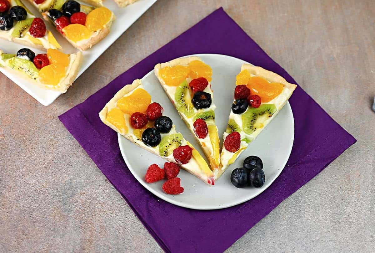 fruit pizza cut into slices.