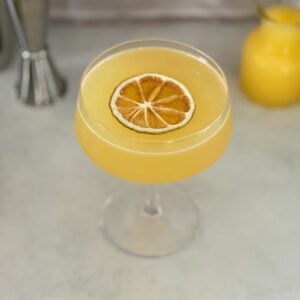 orange creamsicle drink with dehydrated orange garnish.