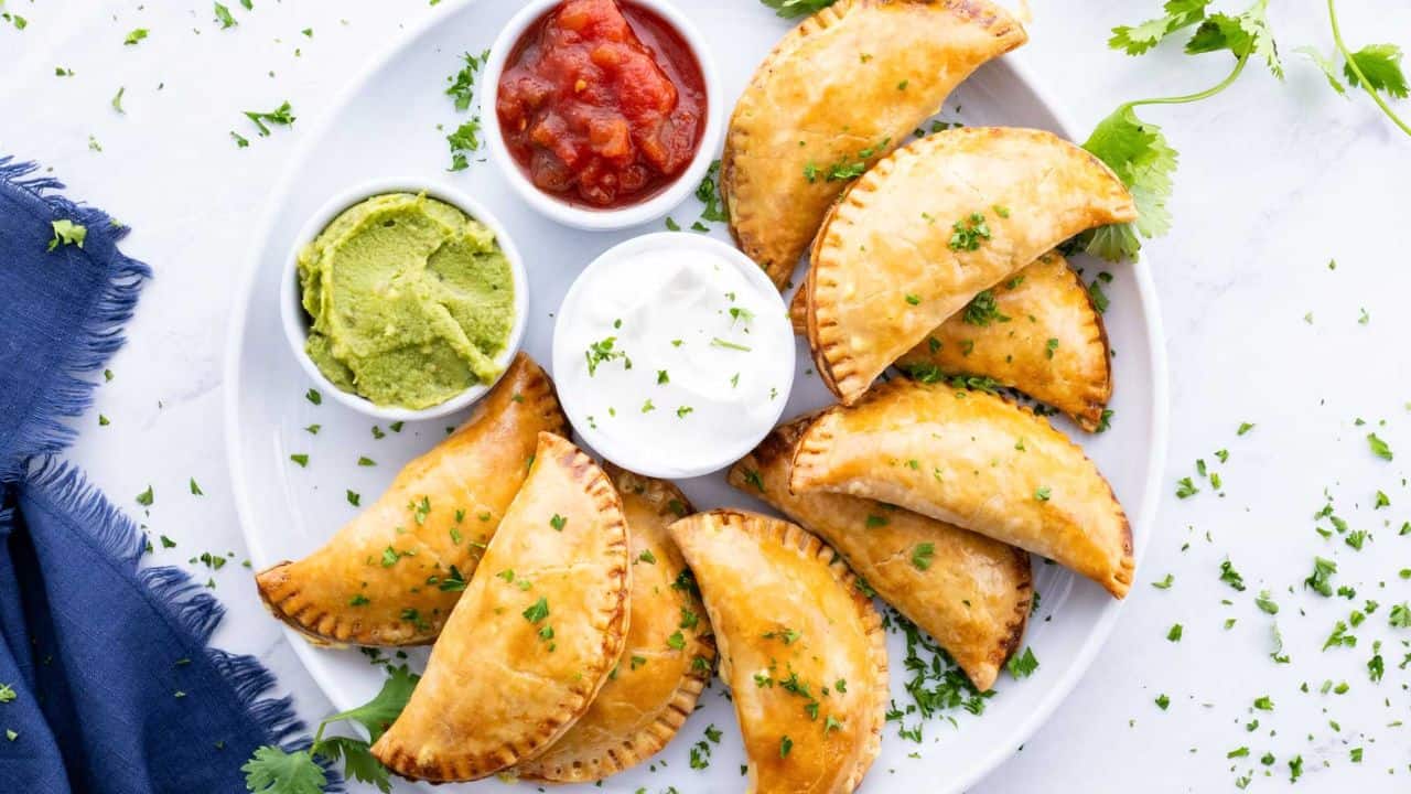 beef empanadas with dipping sauces on the side