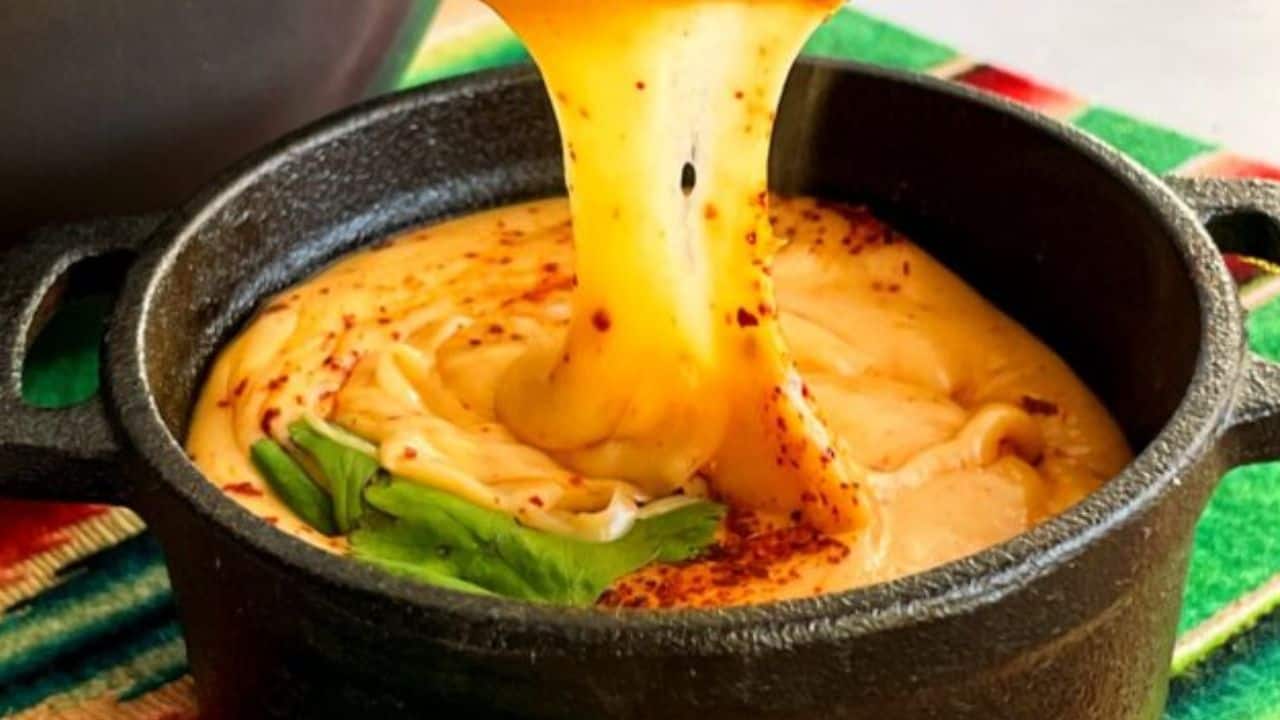 Tequila Queso Fundido in a black metal bowl