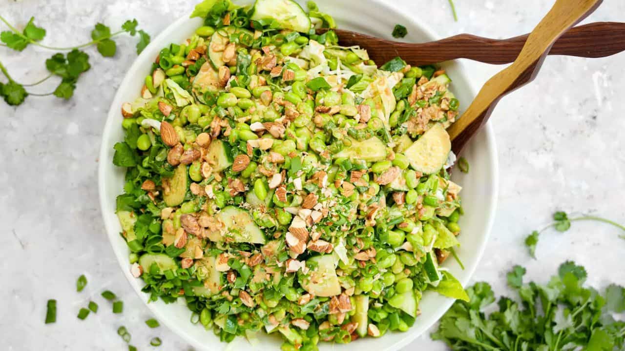 Healthy avocado and nut salad with fresh greens and crunchy toppings.