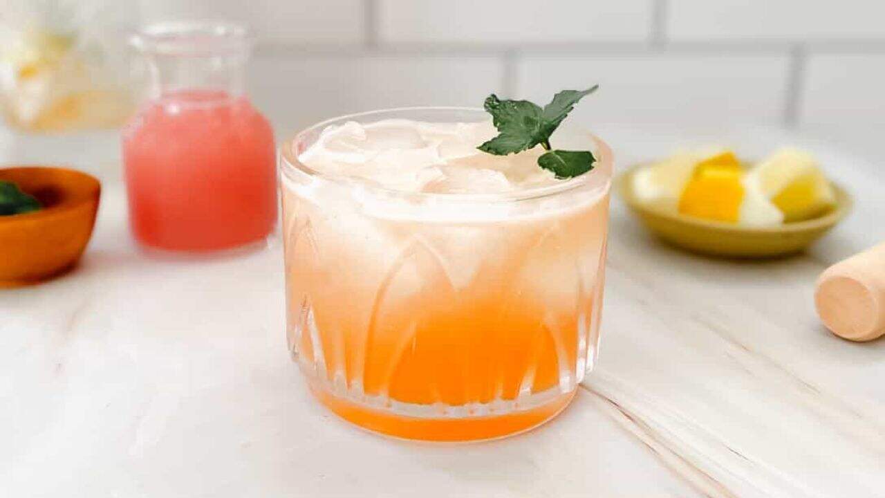 Refreshing guava cocktail with ice and mint, perfect for tropical-inspired drinks.