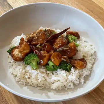 Healthy vegetable stir-fry served on a bed of white rice.